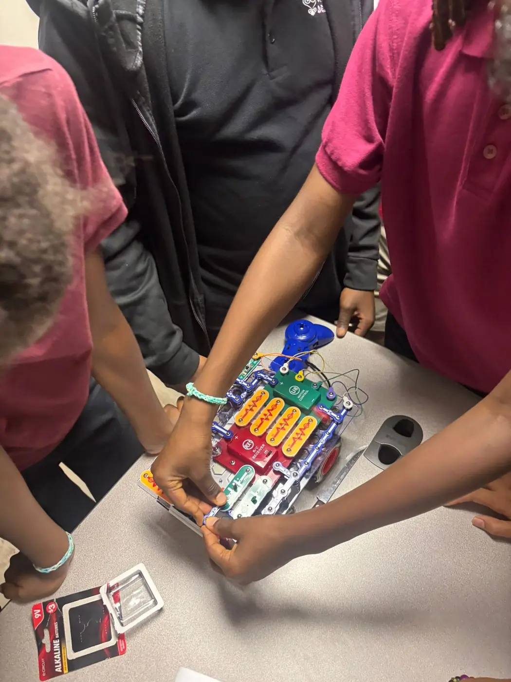Village Academy students working together on a robotics activity